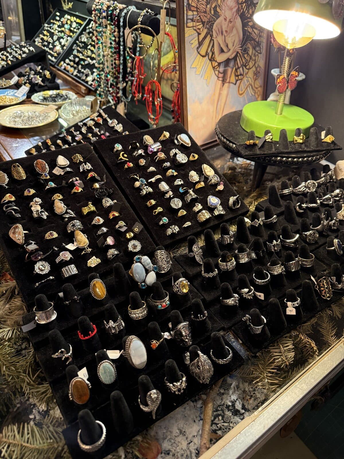 A wall display of dozens of vintage rings — sterling silver, stone, signet, mourning, and novelty.
